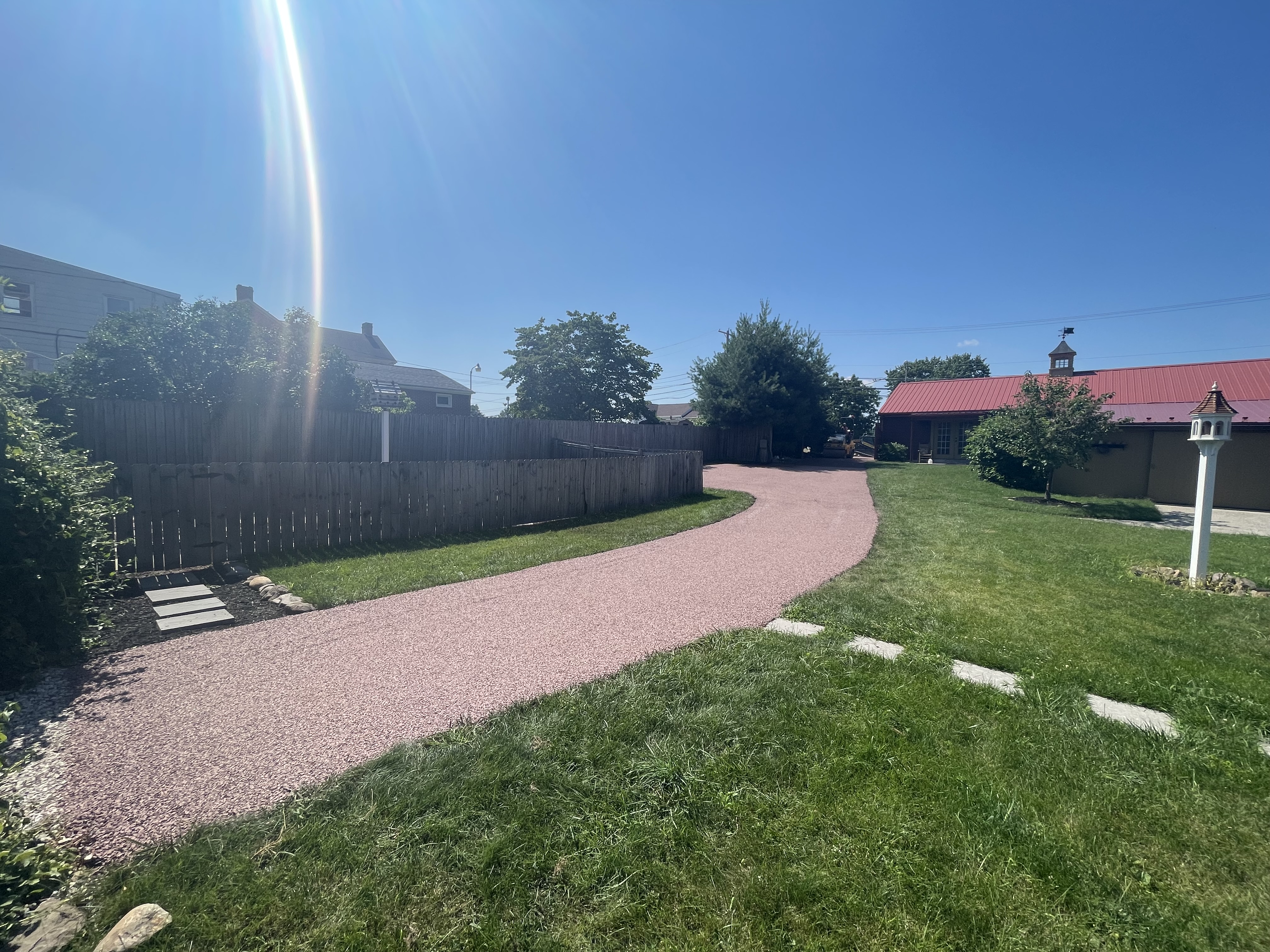 Reddish chip seal pathway finished with tight roll