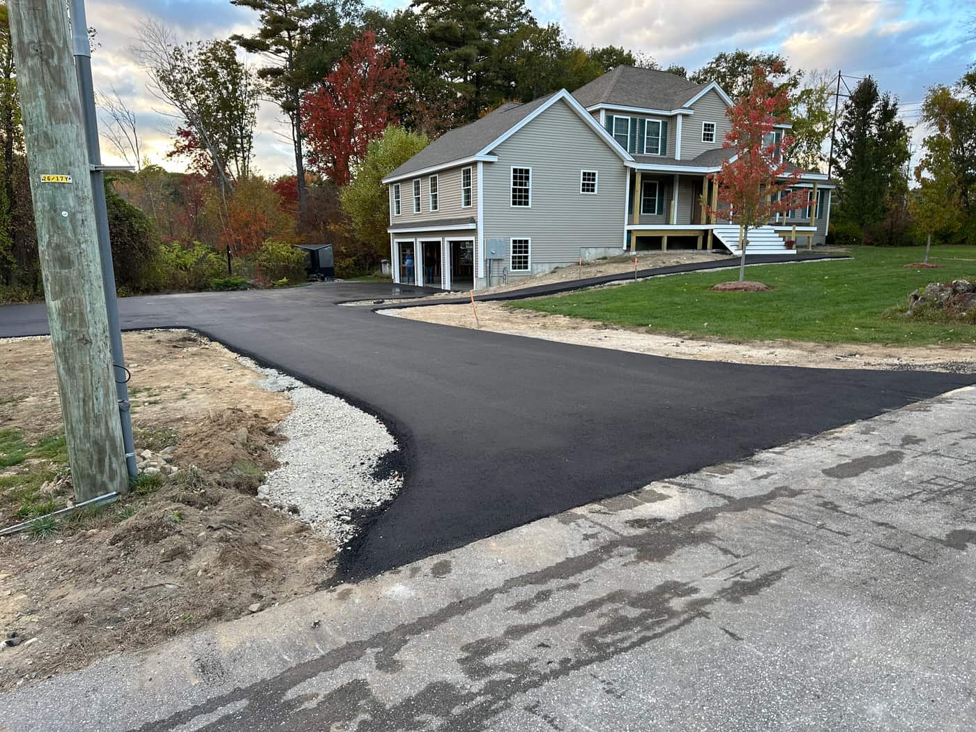 Compactor finishing a driveway edge